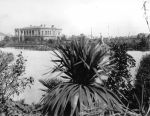 A long shot of Redmond Barry's House from the Exhibition Buildings. Lake and fountain can be seen in middle ground. View of Redmond Barry House from Exhibition Buildings, Circa 1890