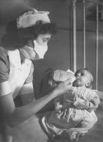 A Nurse Feeding a Baby, Circa 1947 A Nurse Feeding a Baby, Circa 1947