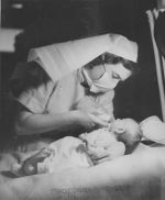 A Nurse Feeding a Baby, Circa 1947 A Nurse Feeding a Baby, Circa 1947