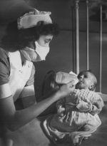 A Nurse Feeding a Baby, Circa 1947 A Nurse Feeding a Baby, Circa 1947