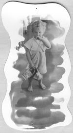 A long shot of a young child wearing shorts and holding two small decorated buckets. Portrait of a Child, Circa 1955