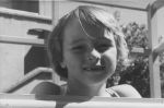 Close up shot of a child outside posing for the camera. Portrait of a Child, Circa 1955