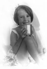 Medium shot of a child seated one leg bent at the knee holding a large metal cup posing for the camera. Portrait of a Child, Circa 1955