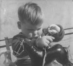 Close shot of a young child playing with a toy horse. Play Time, Circa 1955