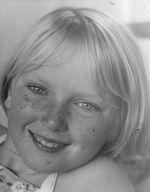 A close up shot of a young child looking at the camera. Child has short fair hair. Portrait of a Child, Circa 1955