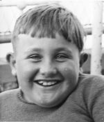 A close up shot of a young child smiling at the camera. Portrait of a Child, Circa 1955