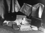 Medium shot of purses, coin bags, satchels, scarves, on floor, various items hanging on wall. Completed Crafts on Display, Circa 1955