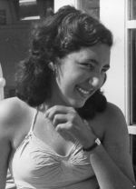 Medium shot of young person standing wearing a watch looking to the side posing for the camera. Portrait, Circa 1955