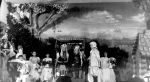A long shot of a group of people and children on a stage dressed in costumes. Pantomime at the Hospital, Circa 1955