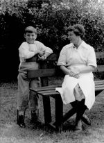 A long shot taken outside of a nurse sitting on a garden bench. There is a young patient with leg braces standing beside her. Nurse and Patient, Circa 1955