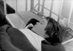A close up shot of a young child asleep in bed with their hands behind their head. Sleep Time, Circa 1955