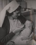 Nurse Bottle-feeding an Infant, Circa 1930 Nurse Bottle-feeding an Infant, Circa 1930