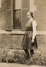 Long shot of adult standing in garden. Young Female in School Uniform, Circa 1922