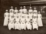 Long shot of a group of staff members, including five in the front row, nine in the middle and six in the back row. Nursing Staff Portrait, Circa 1920