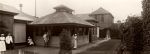 Long shot of exterior of Children's Hospital. Staff are holding children in the photograph. Exterior View Isolation Ward, Circa 1920