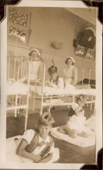 Long shot of two staff members with three children dressed in costumes. Dress Ups, Circa 1941