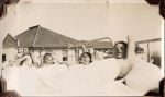 Long shot of patients lying in hospital beds, photograph was taken outdoors. Patients on the Balcony, Circa 1941