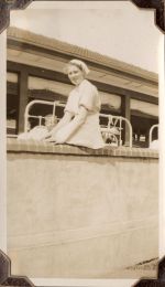 Long shot of a staff member sitting on top of an exterior wall. Nurse on the Balcony, Circa 1941