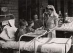Nurse and three children playing board game, Circa 1943 Nurse and three children playing board game, Circa 1943