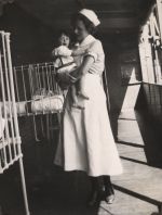Nurse holding infant, Circa 1943 Nurse holding infant, Circa 1943