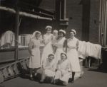 Nurses, one holding infant, Circa 1943 Nurses, one holding infant, Circa 1943