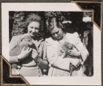 Two women holding puppies, Circa 1943 Two women holding puppies, Circa 1943