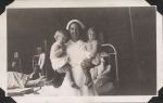 Nurse holds two children, Circa 1943 Nurse holds two children, Circa 1943