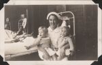 Nurse holds two children, Circa 1943 Nurse holds two children, Circa 1943