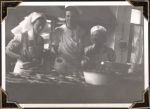 Medium shot of three staff members standing at a table or bench. In the Kitchen, Circa 1945