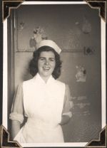 Medium shot of a staff member, standing in front of a wall decorated with cartoon type figures. Portrait of a Nurse, Circa 1945