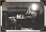 Long shot of two women sitting at the end of a dining table. Dining Room, Circa 1945