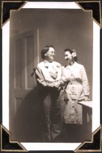 Medium shot of two people posing in room. Door visible on left side of photo. Bride to be, Circa 1945