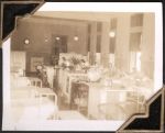 Long shot of a room with hospital beds, windows and work stations. Some staff members can be seen in the background. Women's Hospital, Circa 1946