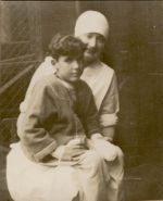 A medium shot of a Nurse sitting outside with a child sitting on her lap. Nurse and Child, 1928
