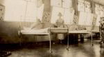 A long shot of a ward decorated with lanterns and flowers. There are children in three beds and another child standing between the beds. They are in costumes. Dress Ups on the Ward, 1928