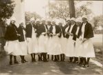 A long shot of a group of twelve Nurses standing outside in the street all with their capes on. Nurses, 1928