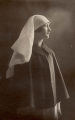 A medium posed shot of a Nurse with her cape on. Portrait of a Nurse, 1928