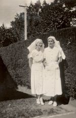 A long shot of a two Nurses standing outside in the garden in the sunshine. Two Nurses, 1928