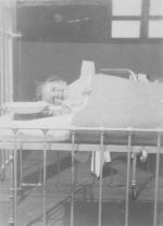 Medium shot of an infant lying in a cot. Smiling Child, Circa 1940