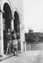 Long shot of two women standing under an archway posing for the camera. On the Balcony, Circa 1940