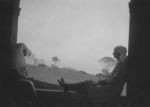 Medium shot of two Nurses sitting on a window ledge. Leaning on the Balcony, Circa 1940