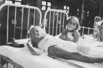 Medium shot of two patients in cots posing for the camera. Patients in Bed, Circa 1940