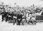 The crowd awaits Queen Elizabeth II to deliver her opening speech